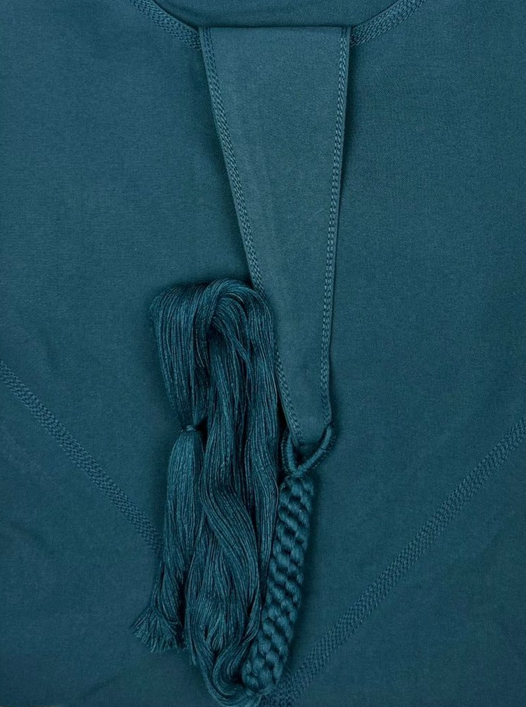 "Folded Premium Teal Blue Emarati Thobe, neatly showing its high-quality fabric and stylish design of its tassel"