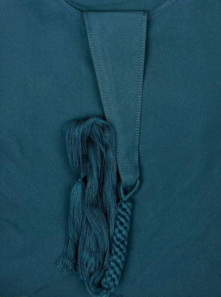 "Folded Premium Teal Blue Emarati Thobe, neatly showing its high-quality fabric and stylish design of its tassel"