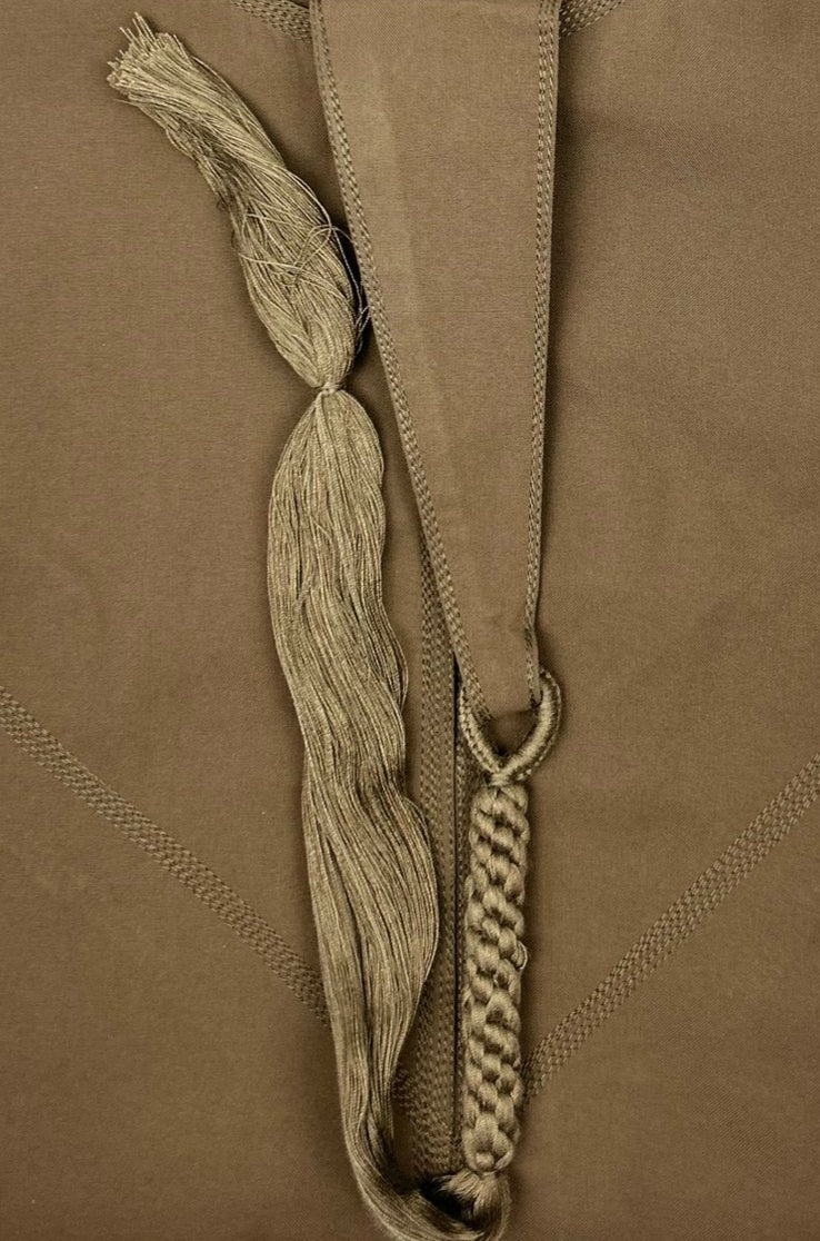 "Close-up of the fabric and stitching on the Basic Brown Emarati Thobe, focusing on the soft texture and durable construction for long-lasting comfort."