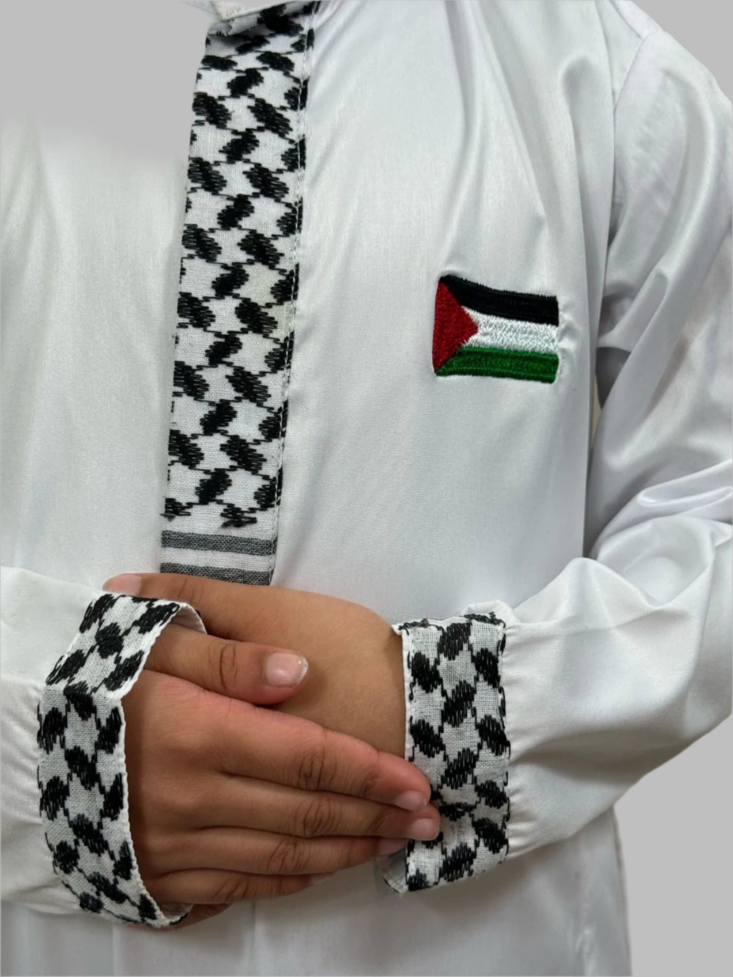 Close-up details of Son Heritage Thobes featuring intricate sleeve keffiyah design and fine Flag embroidered on it