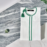 Boys wearing elegant Omani white thobe with green tassel for special occasions