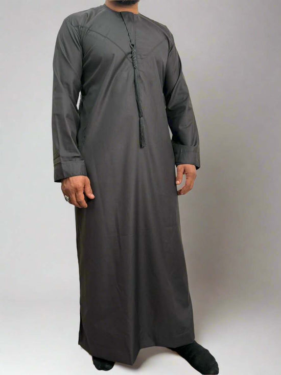 Man wearing Deluxe Emarati Charcoal Thobe in charcoal color for formal events