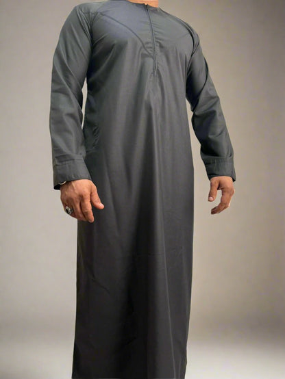 "Model wearing the Deluxe Emarati Charcoal Thobe, demonstrating the perfect fit, modern design, and luxurious charcoal color for formal occasions."