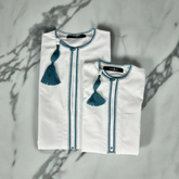 Boys wearing premium Omani white thobe with emerald green tassel for special occasions