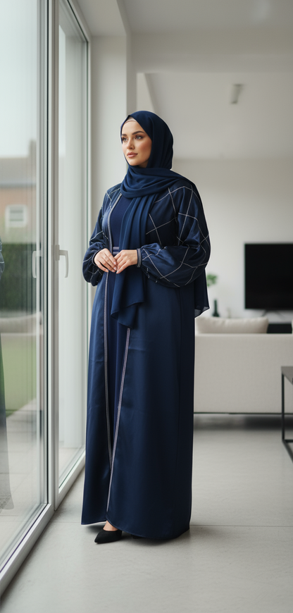 Woman in a blue abaya standing by a window in a modern living room.