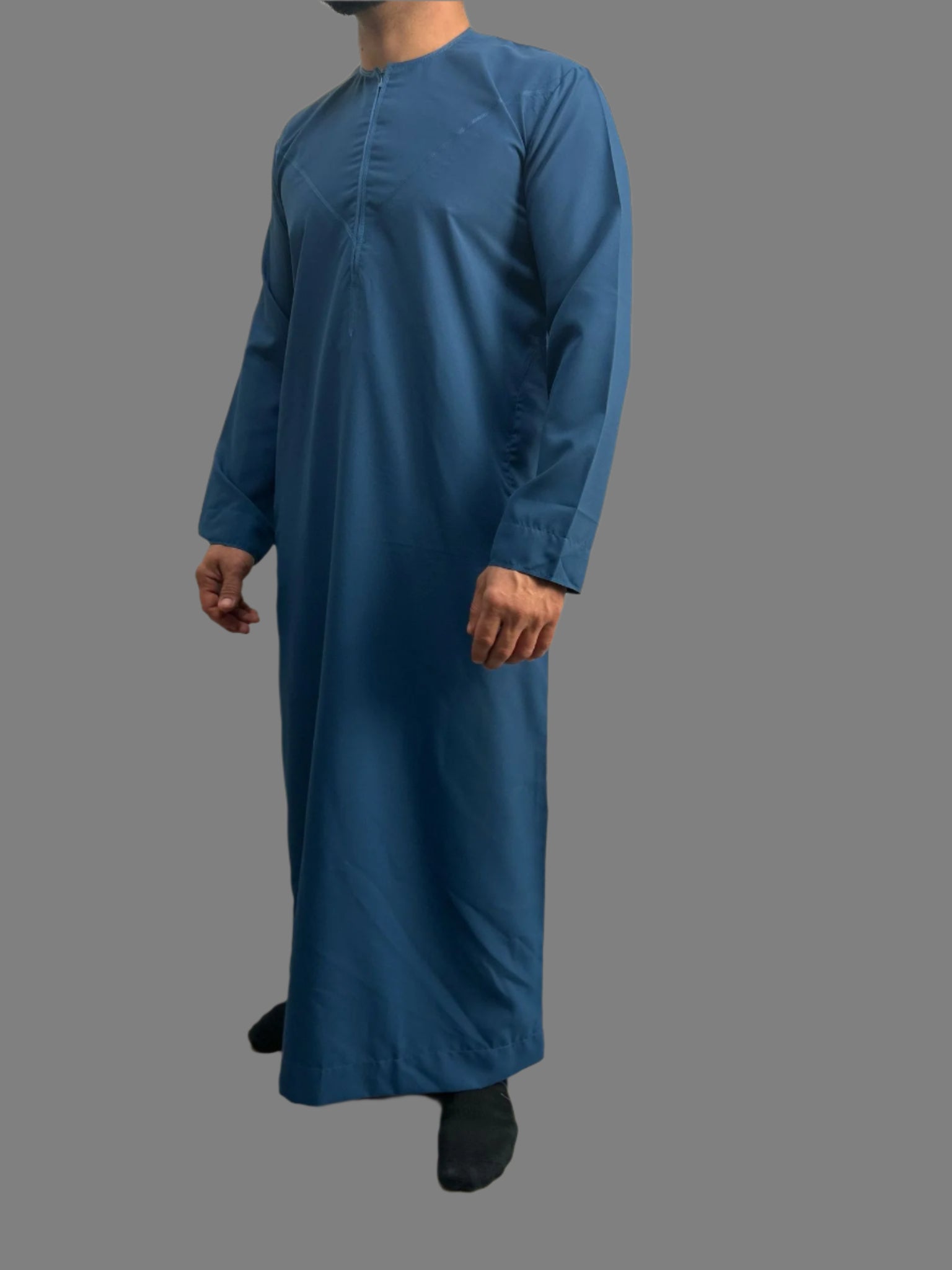 "Side view of the Premium Bright Blue Emarati Thobe, highlighting its sleek silhouette and high-quality craftsmanship, offering a modern yet traditional look for Eid 2025."