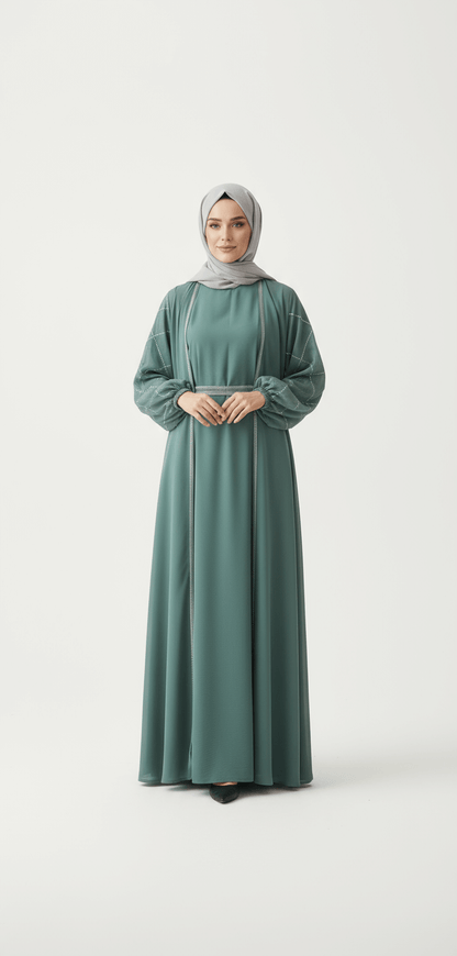 Woman wearing a long green dress and hijab on a white background