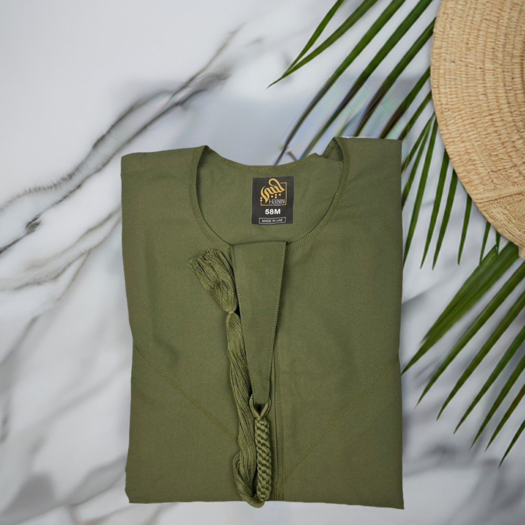 "Folded sage green Emarati thobe, neatly packed to highlight its lightweight, breathable material and easy-to-care-for design."